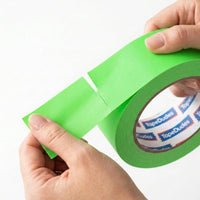 Person easily tearing a strip of neon green matte gaffer tape by tapedudes