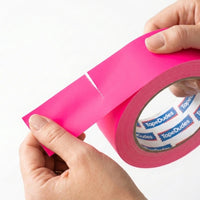 Person easily tearing a strip of neon pink matte gaffer tape by tapedudes